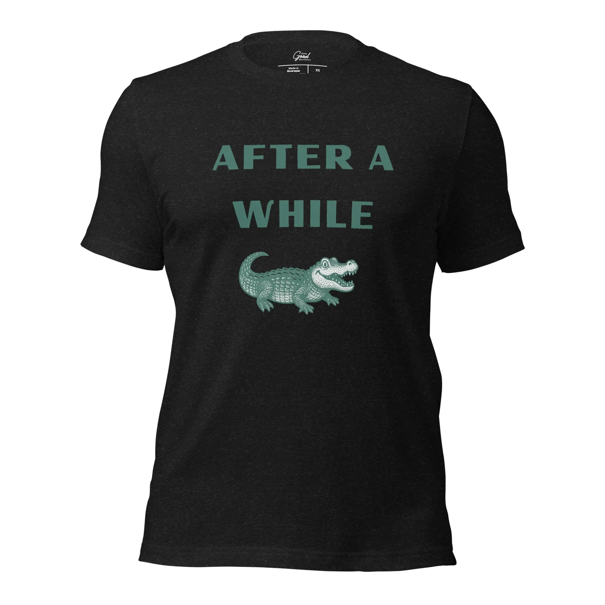 Black Heather After A While Crocodile classic idiom t-shirt featuring the text "AFTER A WHILE" in green above an illustration of a crocodile.