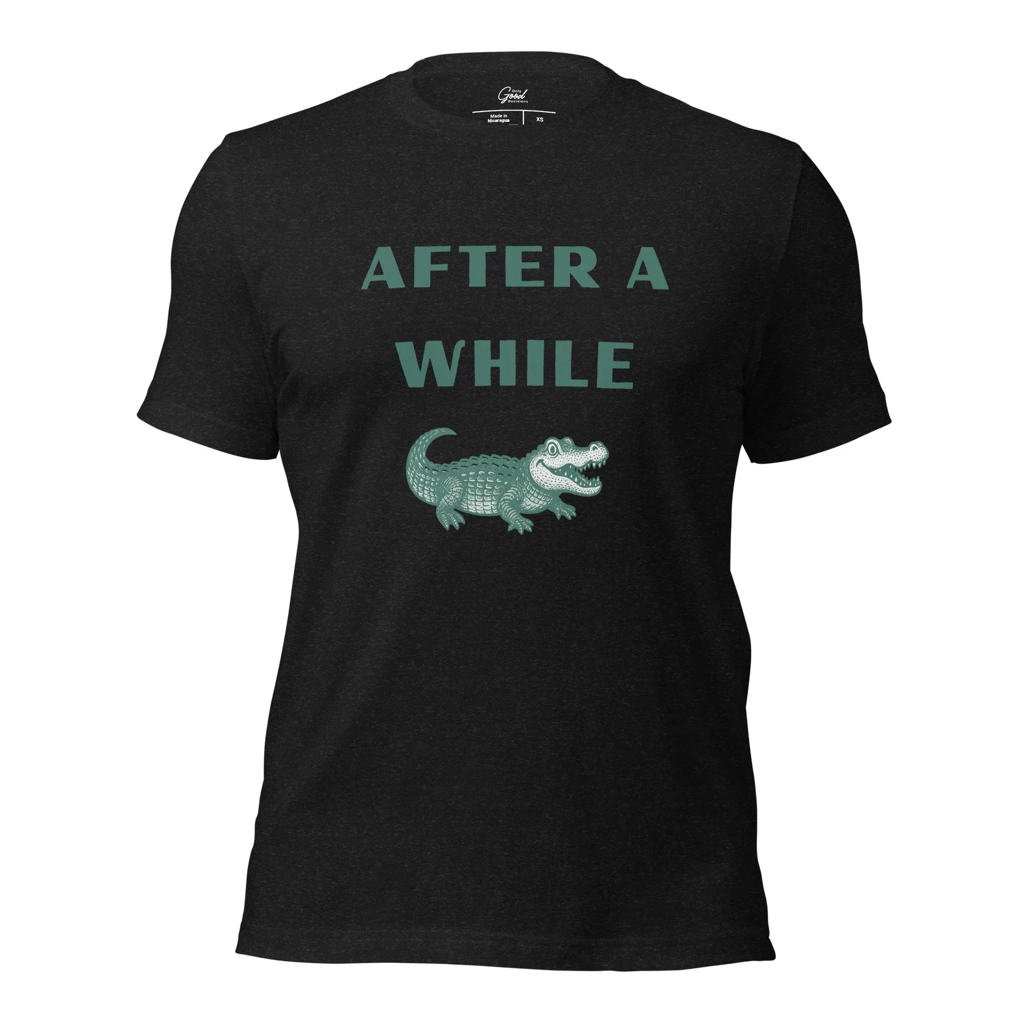 Black Heather After A While Crocodile classic idiom t-shirt featuring the text "AFTER A WHILE" in green above an illustration of a crocodile.
