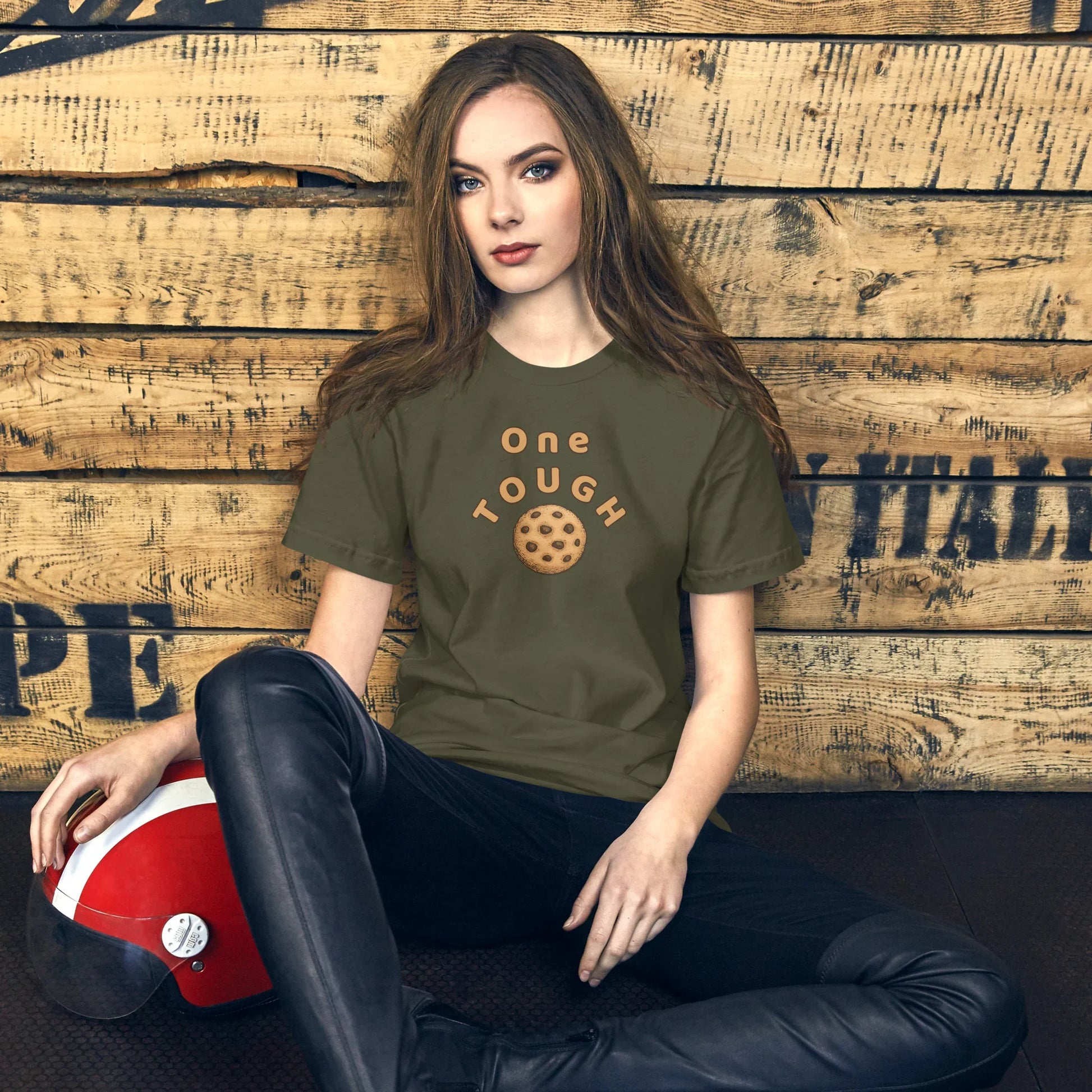 Military Green One Tough Cookie visual pun graphic tee featuring the text "ONE TOUGH" above an illustration of a chocolate chip cookie.